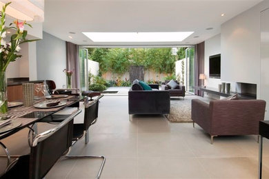 This is an example of a medium sized contemporary open plan living room in London with white walls, ceramic flooring, a corner fireplace, a plastered fireplace surround and a wall mounted tv.