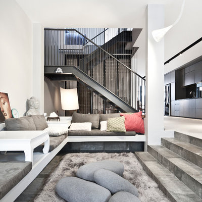 Living room - contemporary formal and open concept concrete floor living room idea in Singapore with white walls