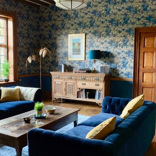 Design ideas for an expansive eclectic formal enclosed living room in Other with blue walls, no tv, brown floors and medium hardwood flooring.
