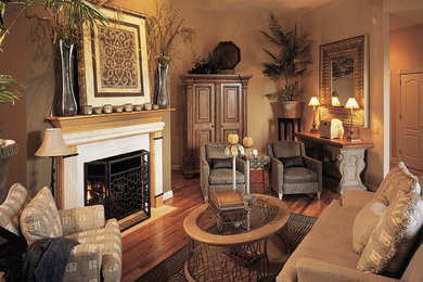 Living room - contemporary medium tone wood floor living room idea in Nashville with brown walls and a standard fireplace