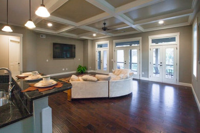 Mid-sized elegant enclosed medium tone wood floor living room photo in Atlanta with beige walls and a media wall