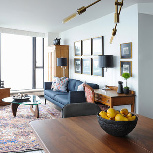 Foto di un soggiorno tradizionale di medie dimensioni e stile loft con pareti bianche, pavimento in ardesia e TV a parete