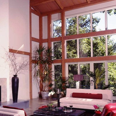 Living room - large farmhouse loft-style concrete floor living room idea in Manchester with white walls, a standard fireplace and a metal fireplace