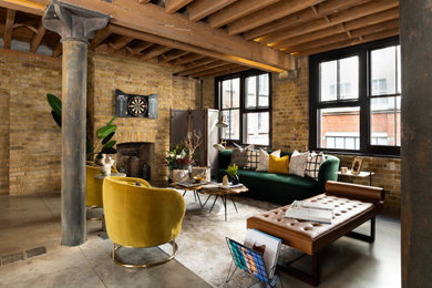 Inspiration for a large urban open plan living room in London with brown walls, a standard fireplace, a brick fireplace surround, grey floors, brick walls and a chimney breast.