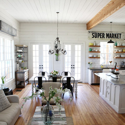 Example of a mid-sized cottage chic open concept medium tone wood floor living room design in Austin with white walls and no tv