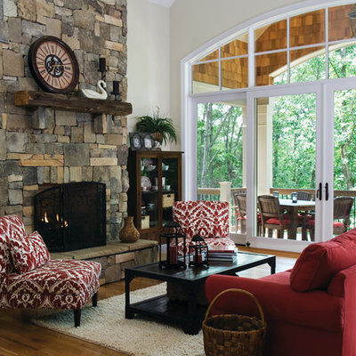 Living room - large traditional open concept medium tone wood floor living room idea in Charlotte with beige walls, a standard fireplace, a stone fireplace and no tv