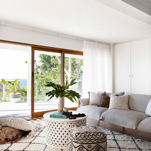 Inspiration for a beach style open concept living room in Gold Coast - Tweed with white walls and medium hardwood floors.