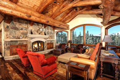 Inspiration for a rustic living room remodel in Denver with a stone fireplace