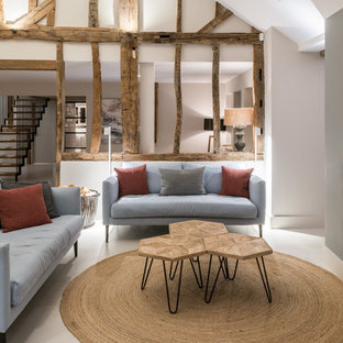 Design ideas for a large rural open plan living room in Other with white walls, limestone flooring, a two-sided fireplace, a metal fireplace surround and white floors.