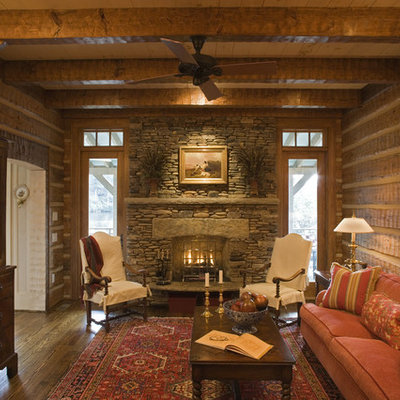 Inspiration for a mid-sized rustic enclosed and formal living room remodel in Other with brown walls, a standard fireplace, a stone fireplace and no tv