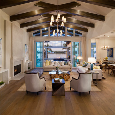 Huge transitional formal and open concept medium tone wood floor and brown floor living room photo in Tampa with beige walls, a standard fireplace and a stone fireplace