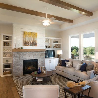 Inspiration for a mid-sized country open concept medium tone wood floor living room remodel in Wichita with white walls, a standard fireplace and a stone fireplace
