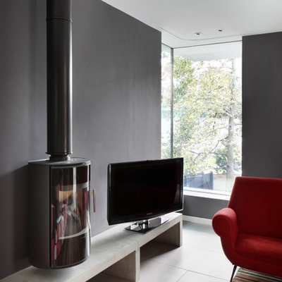 Inspiration for a mid-sized contemporary enclosed porcelain tile living room remodel in London with gray walls, a hanging fireplace and a tv stand