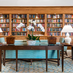 Example of a large trendy open concept carpeted and multicolored floor living room library design in Tampa with brown walls, no fireplace and no tv
