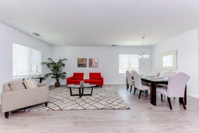 Großes, Repräsentatives, Fernseherloses, Offenes Modernes Wohnzimmer ohne Kamin mit weißer Wandfarbe, hellem Holzboden und grauem Boden in Los Angeles