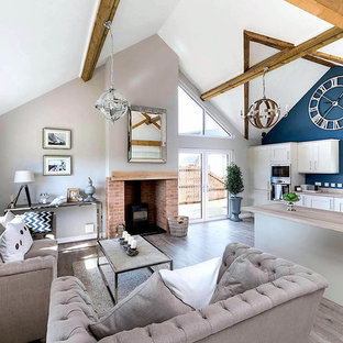 Inspiration for a medium sized nautical open plan living room in Other with a wood burning stove, a brick fireplace surround and grey floors.