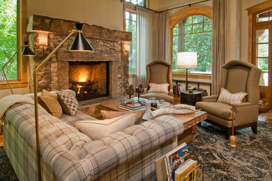 Living room - mid-sized rustic open concept medium tone wood floor living room idea in Denver with a stone fireplace