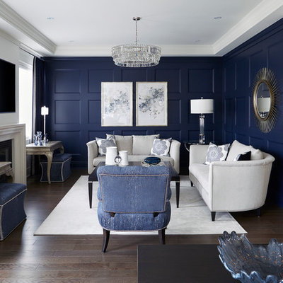 Mid-sized transitional enclosed dark wood floor and brown floor living room photo in Toronto with blue walls, a standard fireplace and a wall-mounted tv