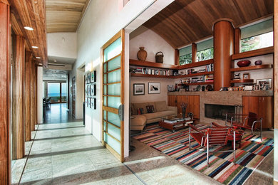 サンディエゴにある広いコンテンポラリースタイルのおしゃれな独立型リビング (ベージュの壁、カーペット敷き、標準型暖炉、石材の暖炉まわり、テレビなし、ベージュの床) の写真
