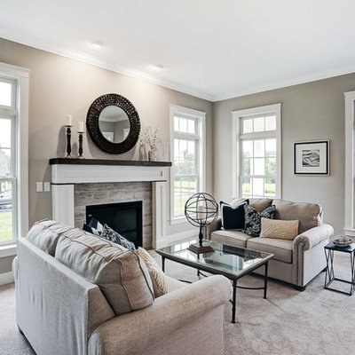 Living room - large farmhouse enclosed carpeted living room idea in Other with beige walls, a standard fireplace, a stone fireplace and no tv