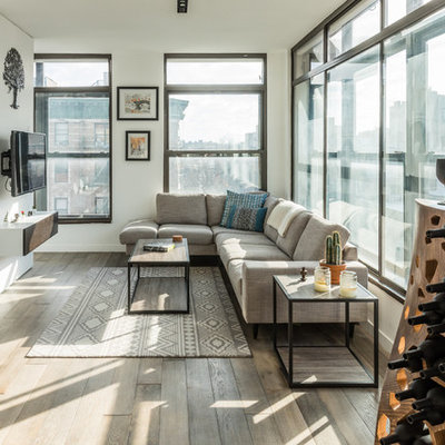 Living room - mid-sized contemporary dark wood floor and brown floor living room idea in New York with white walls and a wall-mounted tv
