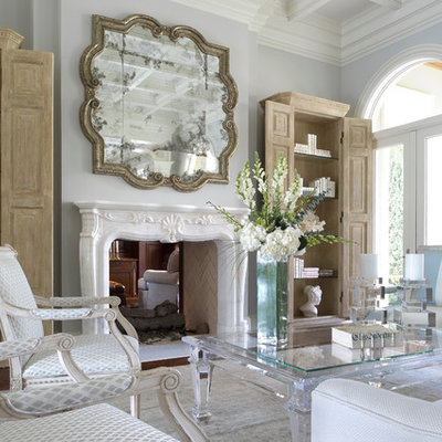 Example of a mid-sized classic formal and enclosed dark wood floor living room design in Miami with a two-sided fireplace, gray walls and a plaster fireplace