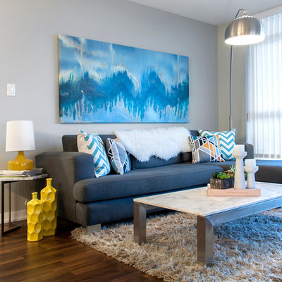 Example of a trendy open concept dark wood floor living room design in Vancouver with gray walls