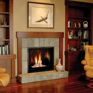 Elegant dark wood floor living room photo in Denver with beige walls, a standard fireplace and a stone fireplace