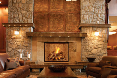 Elegant medium tone wood floor living room photo in Denver with brown walls, a standard fireplace and a tile fireplace