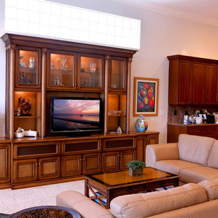 Example of a mid-sized classic open concept beige floor living room design in Miami with white walls and a tv stand