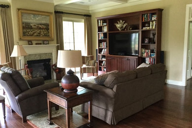 Example of a mid-sized classic open concept dark wood floor living room library design in Atlanta with beige walls, a standard fireplace, a tile fireplace and a media wall