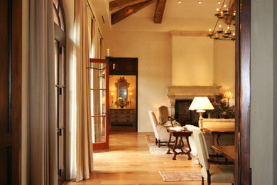 Large mediterranean living room in San Francisco with beige walls, medium hardwood flooring, a standard fireplace and a stone fireplace surround.