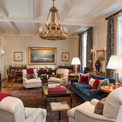 Elegant formal and open concept medium tone wood floor living room photo in New York with beige walls and a wall-mounted tv