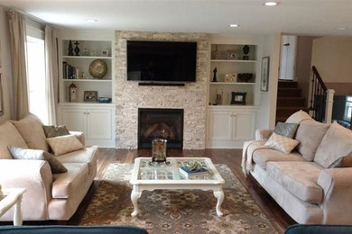 Mid-sized transitional formal and enclosed dark wood floor and brown floor living room photo in Other with brown walls, a standard fireplace, a stone fireplace and a wall-mounted tv