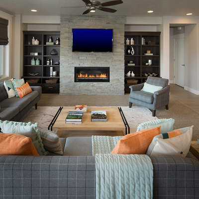 Inspiration for a transitional open concept medium tone wood floor living room remodel in Boise with gray walls, a ribbon fireplace, a stone fireplace and a wall-mounted tv
