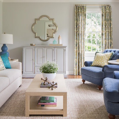 Example of a transitional formal medium tone wood floor living room design in Boston with beige walls