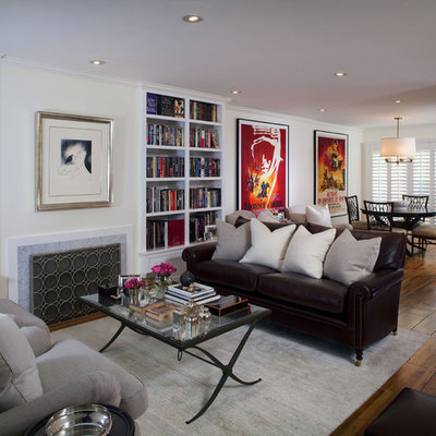 Small trendy formal and open concept medium tone wood floor living room photo in Los Angeles with a standard fireplace, white walls and a stone fireplace