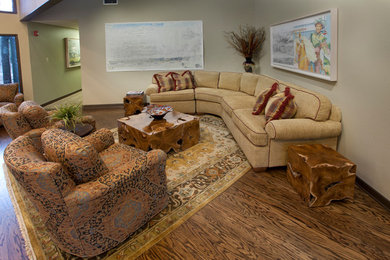 Large elegant open concept dark wood floor and brown floor living room photo in Austin with beige walls and no fireplace