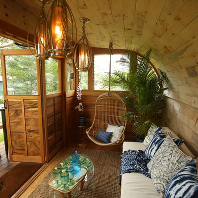 Inspiration for a small tropical enclosed medium tone wood floor and brown floor living room remodel in Hawaii with beige walls, no fireplace and no tv
