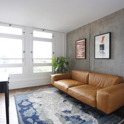 Urban dark wood floor living room photo in London with white walls, no fireplace and a wall-mounted tv