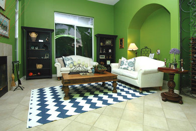 Imagen de salón tradicional con paredes verdes, suelo de baldosas de cerámica, todas las chimeneas y marco de chimenea de baldosas y/o azulejos
