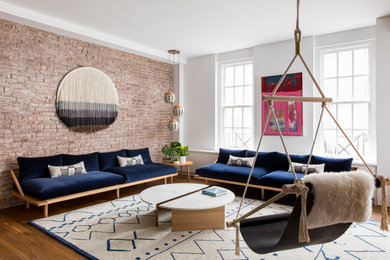 Immagine di un grande soggiorno eclettico stile loft con pareti bianche, pavimento in legno massello medio e nessuna TV