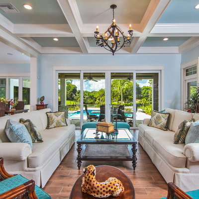 Living room - large tropical formal and open concept dark wood floor living room idea in Miami with blue walls, no fireplace and no tv