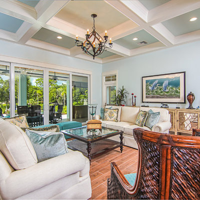 Large island style formal and open concept dark wood floor living room photo in Miami with blue walls, no fireplace and no tv