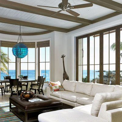 Living room - tropical formal and open concept living room idea in Miami with white walls and no fireplace