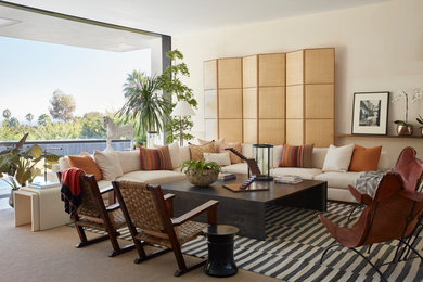 Midcentury formal open plan living room in Los Angeles with beige walls, carpet, no fireplace, no tv and beige floors.