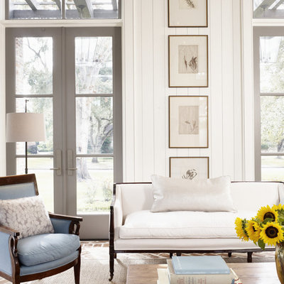 Living room - large country formal brick floor and red floor living room idea in Houston with white walls