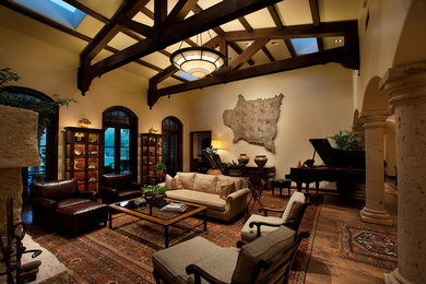Inspiration for a mid-sized mediterranean open concept and formal dark wood floor living room remodel in Phoenix with beige walls, a standard fireplace, a stone fireplace and no tv