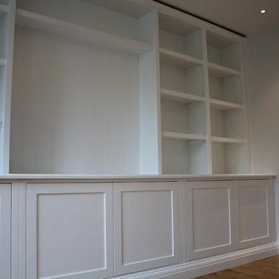 Living room - contemporary living room idea in Hampshire with a media wall