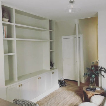 Tv media unit and alcove cabinet with floating shelves.